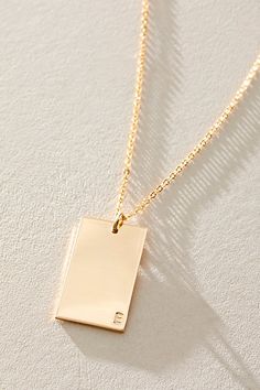 So unique in an understated design, this stunning necklace features a personalized rectangle pendant with initial engraved at corner for a super fun finishing touch. * 14k Gold Filled * 0.5x0.75" rectangle bar necklace with hand-stamped personalization * Length: 20" * 5 days of production | Set & Stones Personalized ie Necklace at Free People in Gold Initial Engraved Necklace, Elegant Silver Rectangular Bar Necklace, Elegant Name Necklace With Rectangular Pendant, Elegant Rectangular Pendant Name Necklace For Gift, Elegant Rectangular Pendant Name Necklace As Gift, Elegant Yellow Gold Initial Necklace With Square Pendant, Elegant Yellow Gold Square Pendant Initial Necklace, Elegant Rectangular Bar Necklace For Personalized Gift, Rectangular Yellow Gold Bar Necklace For Everyday