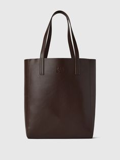 Smooth synthetic leather tote bag.  Shoulder straps at top.  This product was made in a factory that runs the Gap Inc.  P. A. C. E.  Personal Advancement & Career Enhancement) program.  P. A. C. E.  is our educational program that helps the women who make our clothes build the skills, knowledge, confidence & resilience needed to advance in work & life.  Learn more here.  Dimensions: 15"H x 12. 2" W x 5. 1" D Affordable Leather Bags For Back To School, Cheap Office Bags With Zipper Closure, Cheap Collegiate Bags For Everyday Use, Cheap Brown Tote Bag, Ralph Lauren Coffee Tote Bag, Big School Handbags, Cheap Leather Tote Bag, Cheap Student Laptop Bag, Cheap Student Tote Shoulder Bag