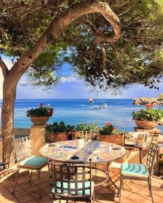 an outdoor dining area overlooking the ocean