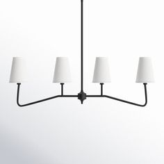 a black chandelier with five white lamps hanging from it's center point