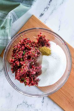 ingredients in a glass bowl on a wooden cutting board