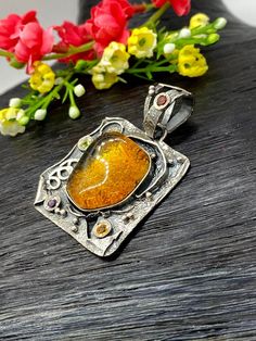 "Artisan Amber gemstone pendant Hand-made Sterling Silver. Stones used: Amber, Peridot, Amethyst, Garnet, Citrine. Height - 51mm, Width - 34mm. Unique Handcrafted One-of a-kind Design Pendant Each Piece of Jewelry in my Collection is Absolutely One of a Kind! When you start wearing a piece of my jewelry you will fall in love with it more and more each day and feel that good Energy and Love that I pass into it while creating this piece of Art. A piece of Art created for you to be inspired and lov Artisan Jewelry With Rectangular Pendant For Gift, Handmade Fusion Necklaces For Gifts, Handmade Fusion Style Necklaces For Gifts, Yellow Jewelry With Artistic Design For Gifts, Artisan Jewelry With Artistic Design For Gifts, Handmade Fusion Style Necklace Gift, Handmade Fusion Style Necklace For Gifts, Amber Large Pendant Jewelry As Gift, Citrine Cabochon Jewelry For Gifts