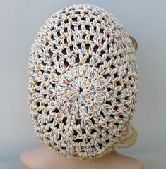 a crocheted hat on top of a mannequin head