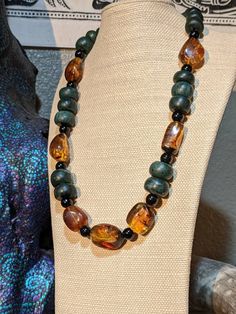 This necklace is made from Chiapas amber and Guatemalan jade Amber (Mexican) Mexican amber is mainly recovered from fossil bearing rocks in the Simojovel region of Chiapas, Mexico. It is one of the main minerals recovered in the state of Chiapas, much of which is 25 million years old, with quality comparable to that found in the Dominican Republic. Chiapan amber has a number of unique qualities, including much that is clear all the way through and some with fossilized insects and plants. Most Ch Gift Natural Stones Baltic Amber Necklaces, Baltic Amber Necklace With Natural Stones For Gift, Gift Necklace With Baltic Amber And Natural Stones, Gift Necklaces With Baltic Amber And Natural Stones, Artisan Brown Jewelry With Natural Inclusions, Brown Jade Jewelry For Healing, Spiritual Amber Beaded Necklace With Natural Stones, Spiritual Amber Beaded Necklaces With Natural Stones, Handmade Baltic Amber Spiritual Jewelry