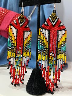 Introducing the Tribe Earrings! With multi-colored beads, these unique and bold earrings will set you apart from the rest. Suitable for the modern-day tribalista, these earrings are a guaranteed conversation starter! Show off your bohemian vibes and don't forget to take a selfie! Southwestern Dangle Beaded Earrings For Festivals, Southwestern Style Beaded Dangle Earrings For Festival, Southwestern Style Dangle Beaded Earrings For Festivals, Bohemian Chandelier Earrings With Colorful Beads, Handmade Colorful Earrings For Festival, Colorful Handmade Earrings For Festivals, Southwestern Style Large Beads Earrings For Gift, Southwestern Multicolor Round Bead Earrings, Adjustable Dangling Beads Earrings For Festivals