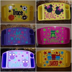 four different colored trays with mickey mouse and minnie mouse decals on the sides