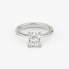 a princess cut diamond engagement ring on a white background with the center stone in the middle