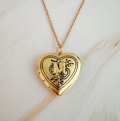 The Nostalgic Heart Initial Open Locket Necklace adds a touch of vintage charm to any outfit. The heart-shaped locket is perfect for everyday wear and can be layered with other necklaces for a unique look. Share your initial or keep a loved one close to your heart. Dimensions: approximately 18" chain with a 2" extender, locket is about 1" x 1" 18k gold plated brass for locket, stainless steel chain Lead and Nickel free Made in China Open Locket, Visor Hairstyles, M Necklace, Everyday Gifts, Heart Locket, Fine Jewelry Collection, Locket Necklace, Scrunchie Hairstyles, Steel Jewelry