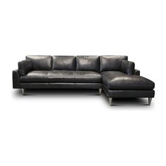 a black leather sectional sofa sitting on top of a white floor