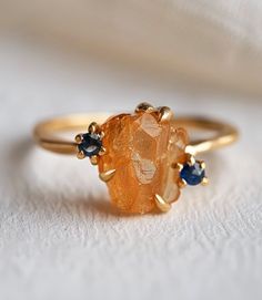 *Gem: Citrine, sapphires (can be customized with other stones as well) *Send us a message to select your favorite citrine gemstones💛🧡 All 12 months birthstones are available for accent stones. Pick any in your choice:) *Metal Solid Silver/14k Gold: These are the metals for durable 24/7 every day wear.  *Our raw stones are hand selected, and set on a beautiful shank for a one-of-a-kind work of art. Every art piece is handmade and varies slightly, just made for the same unique you! *Please note Elegant Orange Sapphire Ring As Gift, Elegant Orange Sapphire Ring Gift, Orange Topaz Ring With Accent Stones For Gift, Orange Topaz Ring With Accent Stones As Gift, Orange Topaz Ring With Center Stone For Gift, Orange Topaz Ring With Center Stone As Gift, Orange Topaz Ring With Accent Stones, Sapphire Crystal Ring Gift, Amber Crystal Promise Ring