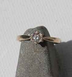 a diamond ring sitting on top of a rock