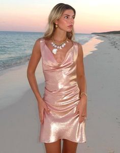 Metallic rose gold silk lamé cowl neck dress. Cowl neckline Low back with V-straps  Italian metallic lamé fabric  Fits close to body with flounce bottom Made in Italy  Fabric content: 85% silk, 15% metallic lurex Care instructions: dry clean only Fit: model is 5'9 and wears a size XS. Size S measurements: Length from shoulder: 35" Complete the look: Sequin Flower Tie Rose Gold Slip Dress, Rose Gold Silk Dress, Gold Rose Dress, Lamé Fabric, Siren Dress, Silk Organza Dress, Eden Dress, Lame Dress, Sequin Flower