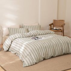 a bed sitting on top of a wooden floor next to a chair