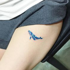 a blue whale tattoo on the right thigh