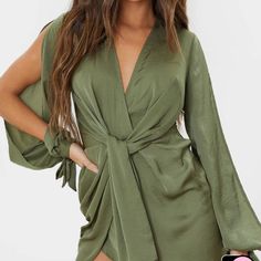 Add An Effortless Vibe To Your Look With This Wrap Dress. Featuring An Olive Satin Fabric With A Twist Front Wrap Design And An Open Sleeve Detail. Length Approx 33.5" Model Wears Size Us 4 Chic Wrap Dresses For Brunch, Sleeveless Wrap Dress For Spring Night Out, Sleeveless Wrap Dress For Night Out In Spring, Wrap Dresses For Spring Brunch, Tie Waist Mini Dress For Brunch, Fitted Wrap Mini Dress For Summer, Summer Wrap Mini Dress With Tie Waist, Spring Mini Dress With Tie Waist For Date Night, Spring One-shoulder Dress With Tie Waist