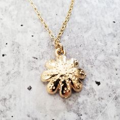 Step into a world of playful elegance with this Gold Dainty Daisy Charm Necklace. This adorable piece of jewelry is here to add a touch of enchantment to your everyday style. It's like capturing a piece of nature's cheerfulness and wearing it as a symbol of your vibrant spirit. This necklace brings a lighthearted touch to any outfit, whether you're dressing up for a special occasion or adding a playful accent to your casual look. Its dainty design and shimmering gold finish effortlessly elevate Handmade Adjustable Charming Necklaces, Handmade Charming Adjustable Necklaces, Handmade Adjustable Charming Necklace, Dainty Metal Flower Shaped Jewelry, Flower Charm Necklaces As Gift, Delicate Adjustable Pendant Charm Necklace, Dainty Nickel Free Charm Necklace As Gift For Her, Dainty Metal Jewelry In Flower Shape, Yellow Gold Flower Pendant Jewelry As Gift For Her