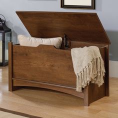 a bed with a wooden headboard and foot board on top of wood flooring