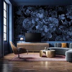 a living room with blue walls and flowers on the wall behind it, along with a large tv