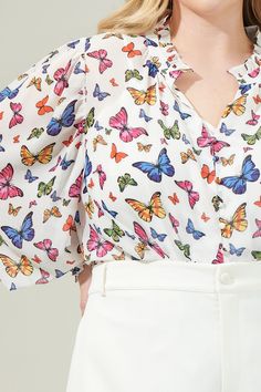 The Bess Butterfly Long Sleeve Blouse is ready for a beautiful sunny day, no matter where that may be! How adorable is the multi color butterflies on this blouse with long sleeves and smocking around the cuffs. A split neckline and ruffles follow along the top. Wear it with white or pink pants to complete this look! - Split neckline- Smocked cuffs- Ruffle trim- Lined- Color: White MultiSize + Fit - Model is 5'8" and wearing size 2X- Measurements taken from size 2X- Chest: 26 1/2"- Length: 28 1/2 Spring Butterfly Print Long Sleeve Tops, Spring Butterfly Print Tops, White Short Sleeve Top With Butterfly Print, Blouse With Long Sleeves, Spring Long-sleeve Tops With Butterfly Print, Beautiful Sunny Day, Casual Multicolor Butterfly Print T-shirt, Pink Pants, Sunny Day