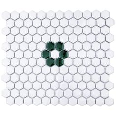 a white and green tile with hexagonal shapes