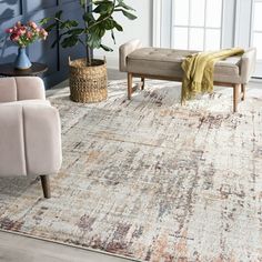 a living room area with blue walls and rugs on the floor, two couches and one chair