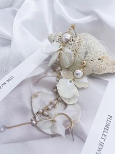 Elegant White Pearl Embellished Earrings, Feminine Evening Pearl Earrings, Feminine Pearl Earrings For Evening, Pearl White Bridal Earrings With Pearl Chain, Graceful Pearl White Pearl Earrings, Elegant Pearl Drop Clip-on Earrings, Elegant Flower Drop Earrings For Evening, Elegant Pearl White Pearl Earrings For Party, Elegant Evening Flower Drop Earrings