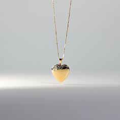 *CHAIN IS NOT INCLUDED. Own a tangible representation of love in the most elegant way. This 14K solid gold heart-shaped pendant is the most sophisticated way of showing love to someone who is dear to your heart. Whether that be yourself or a significant other. This gold heart locket pendant will captivate not only the eyes but also the heart of the person who will receive it. Made from the finest 14K solid gold material, this heart-shaped pendant is a real symbolism of luxury and of love. Make i 14k Gold Heart Pendant Locket For Anniversary, Gold Heart Pendant Locket Necklace With Hallmark, Elegant Heart-shaped Yellow Gold Locket Necklace, Elegant Heart Necklace For Keepsake, Elegant Yellow Gold Heart Necklace Keepsake, Elegant Yellow Gold Heart Necklace For Keepsake, Gold Heart Locket Necklace 14k, Heart-shaped 14k Yellow Gold Locket Necklace, Gold 14k Locket Heart Necklace