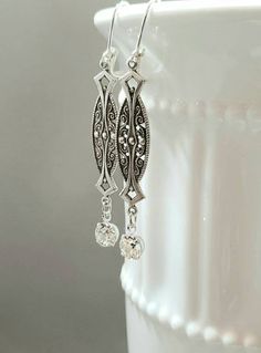 Textured Front, Hollow Back These 1920s inspired earrings feature silver plated Art Deco style brass connectors and sparkling clear Swarovski crystal beads. The dainty brass connectors are very lightweight yet sturdy and slightly hollow on the reverse side. (SEE 2nd PHOTO) They remind me of delicate Edwardian lace. They measure 2 1/2 inches long from the top of the silver plated lever back ear wires to the bottom of the crystal beads An elegant combination for a vintage inspired wedding. ABOUT T Art Deco Earrings Bridal, Flapper Jewelry, Art Deco Jewelry 1920s, 1920s Earrings, Gatsby Earrings, 1920s Jewelry, Bridal Art, Art Deco Filigree, Great Gatsby Wedding