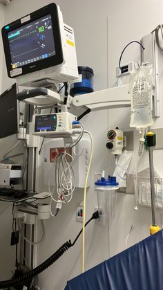 a hospital room with medical equipment and monitors on the wall, including an oxygen tube