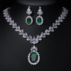 Experience the epitome of elegance with our Luxury Emerald Bridal Jewelry Sets. These exquisite pieces feature captivating green emerald-like stones crafted from AAA Cubic Zirconia, meticulously set in a pendant necklace and coordinating earrings. Designed to enhance your allure at any special occasion, from weddings to glamorous parties and elegant dinner events, these sets embody a timeless sophistication. Style: TRENDY Shape\pattern: Geometric Occasion: Wedding Metals Type: Copper Alloy Mater Emerald Jewelry Aesthetic, Emerald Bridal Jewelry, Emerald Green Jewelry Set, Green Jewellery Set, Dark Green Jewelry, Emerald Jewelry Necklace, Emerald Necklace Set, Emerald Jewelry Set, Green Necklace Set