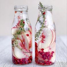 two glass jars filled with food on top of a table