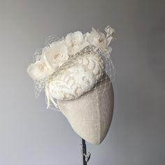 READY TO SHIP TODAY ☀ Follow this link for more beautiful choices from 'Indigo Hats'  https://www.etsy.com/shop/IndigoHats ☀ Handmade with care by Jaine. This charming hat is handblocked in a natural creamy sinamay straw.   It has a subtle sequin applique in ivory and a bough of beautiful silk milinery flowers, also in ivory.  A coordinating ivory veiling with a flurry of veiling around the back completes the look.   The base of the hat measures approx. 7" across.  It has a comfortable elastic to hold securely on and is lined in silk. Please let me know if you have any questions at all - I am always here to help:) - Jaine ☀ Find your perfect fascinator here from 'Indigo Hats' https://www.etsy.com/shop/IndigoHats ☀ Thank you for considering one of my headpieces for your special occasion! Vintage White Hat Headpiece, White Hat For Vintage Events, Wedding Costume Hats And Headpieces With Handmade Flowers, Elegant Wedding Hats And Headpieces With Handmade Flowers, White Curved Brim Fascinator For Vintage Events, Elegant White Hat For Vintage Events, Elegant White Hats For Vintage Events, Adjustable Wedding Fascinator, Adjustable Fascinator For Wedding