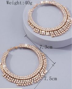 These women exaggerated rhinestone tassel big hoop earrings are a show stopper! Perfect for date night or the holidays. Pair it with your favorite dress, leather look or tank for a star studded look. Description: Color: Gold Gender: Women Material: Glass Earring Studs Materials: Stainless Steel Measurements in inches: Size Eardrop Height Eardrop Width one-size 2.9 3 Luxury Metal Hoop Earrings For Party, Bling Metal Hoop Earrings For Party, Metal Bling Hoop Earrings For Parties, Trendy Sparkling Hoop Earrings For Party, Party Metal Hoop Earrings With Bling, Metal Hoop Earrings With Rhinestones For Party, Rhinestone Metal Hoop Earrings For Parties, Chic Dangle Hoop Earrings For Evening, Party Metal Hoop Earrings With Rhinestones