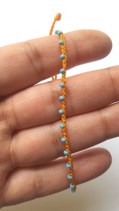 "♡Listing is for one dainty seed bead bracelet or anklet as featured and your choice of card♡ Perfect for everyday wear. Super dainty and minimalist look. Great way to add a little color to any outfit. Makes a very dainty stacking bracelet too. *Featured: Cord color-Tangerine Beads- Sky Blue Closure- A. With Beads *Material: Item is made with sturdy nylon cord. The cord resembles silk and color will not fade away. Tiny glass seed beads are carefully hand braided as the highlight of this item. *C Blue Tiny Beads Anklet For Gift, Blue Anklet With Tiny Beads For Gift, Blue Beaded Chain Anklets As Gift, Blue Beaded Chain Anklets For Gift, Handmade Turquoise Anklet Bracelet, Minimalist Handmade Anklets With Round Beads, Dainty Beaded Chain Anklets With Round Beads, Blue Anklets With Tiny Beads, Minimalist Handmade Beaded Anklets