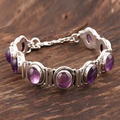 Oval amethyst poses in sterling settings like perfect plums. From Bhavesh this silver bracelet is a modern classic. .925 Sterling silver Silver Amethyst Bangle Bracelet, Silver Amethyst Bangle Bracelets, Sterling Silver Amethyst Bracelet With Gemstone, Spiritual Silver Amethyst Bracelets, Spiritual Silver Bracelet With Amethyst, Adjustable Amethyst Sterling Silver Bracelet, Silver Bracelet With Amethyst Natural Stones, Amethyst Silver Jewelry With Polished Finish, Silver Amethyst Bracelet With Natural Stones