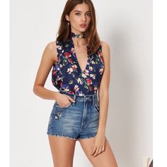 A Pretty Little Bow Secures The Back Of This Playfully Cut-Out Floral-Print Blouse Styled Sans Sleeves For Warm Weather. - Ties Behind The Neck - Band Collar With V-Neck Cutout - Sleeveless - Approx. 26" Length, 100% Polyester Model's Stats For Sizing: - Height: 5'9" - Bust: 34" - Waist: 23" - Hips: 34" Model Is Wearing Size S. 1623814n16/011122 Floral Print Summer Tops For Night Out, Summer Floral Print Blouse For Night Out, Lace Front Top, Bandeau Crop Top, Lace Top Long Sleeve, Chiffon Ruffle, Crochet Crop Top, Bell Sleeve Blouse, Scoop Neck Top