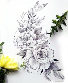 a drawing of flowers on paper next to some green leaves and yellow flower buds in the background