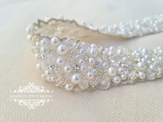 a white headband with pearls and crystal beads