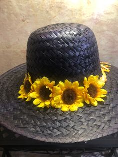 Beautiful lightweight mahogany straw hat with sunflowers and tied raffia band in contrasting shades of sunny yellow and orange. Fits head circumferences from 21 inches to 23 inches. Great hat for any occasion and because the hues are so easy on the eye you're sure to wear it for years to come. Adjustable Summer Sun Hat With Flower Design, Adjustable Summer Sun Hat With Flower Shape, Adjustable Summer Flower Sun Hat, Summer Garden Party Costume Hat With Flower Shape, Adjustable Flower Hats For Vacation, Summer Straw Hat With Adjustable Flower Shape, Adjustable Sun Hat With Flower Design For Vacation, Adjustable Yellow Hats For Garden Party, Adjustable Yellow Hat For Garden Party