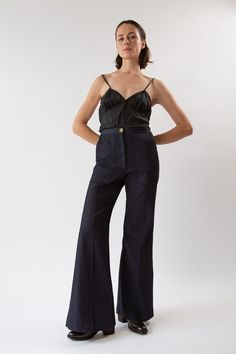 The Darby is our best-selling high-waisted, flared stretch denim pant with front patch pockets and a pintuck stitched down front of each leg. With a subtle 70's svelte silhouette, Darby fits the figure beautifully. Pairs perfectly with slouchy sweaters, fitted blazers, or a simple tee or silk camisole. Erica Tanov This garment is made of a raw denim that has been left in its pure, untreated state. To avoid dye transfer, we recommend an initial separate cold water wash and line dry, which will re Erica Tanov, Stretch Denim Pants, Slouchy Sweater, Classic Pants, Silk Camisole, Simple Tees, Silk Slip Dress, Dark Indigo, Raw Denim