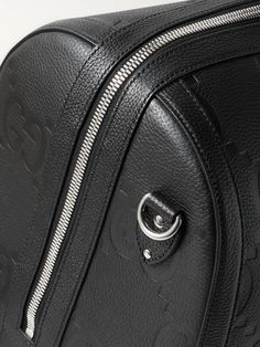 Gucci's duffle bag has been crafted in Italy from monogrammed full-grain leather and can be locked for peace of mind while travelling. It opens wide for easy access to your belongings and comes with a detachable shoulder strap. Get the matching briefcase to look polished on business trips. Gucci Leather Shoulder Bag With Zipper Closure, Gucci Leather Bag With Zipper Closure, Gucci Bags With Leather Lining For Daily Use, Designer Duffle Bag With Top Handle, Daily Use Gucci Bags With Leather Lining, Designer Leather Travel Bag, Luxury Top Handle Luggage, Luxury Luggage With Top Handle, Leather Bags With Silver-tone Hardware For Business Trips