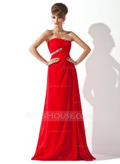 a woman in a red dress posing for the camera with her hands on her hips