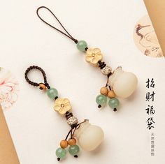 two pieces of jewelry with beads and flowers hanging from it's earwires