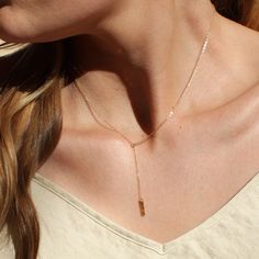 "Our dainty lariat necklace is stylish and minimalist. This dainty necklace is perfect with your favorite tee or your little black dress. A tiny bar adorns a silver or gold chain.  D E T A I L S *Dainty 12mm bar  *Hammered by hand  *2 inch drop  *Dainty link chain *100% 14kt gold-filled or sterling silver LENGTH *The standard length is normally 18\". *Model is wearing a 16\" in Photos. HOW TO PERSONALIZE *Select your choices from the drop down menu to create your custom design. ∙ EXTRA LOVE ∙ Handcrafted just for you in sunny Arizona by a team of talented women. All of our jewelry comes gift packaged! We are happy to leave a note if this is a special gift, just let us know in the message box at checkout. PRODUCTION ∙ TIMES All items are made to order. Please check the estimated delivery in Adjustable Rose Gold Dainty Lariat Necklace, Adjustable Dainty Rose Gold Lariat Necklace, Dainty Adjustable Rose Gold Lariat Necklace, Delicate Rose Gold Lariat Necklace Gift, Dainty Rose Gold Lariat Necklace, Adjustable Lariat Drop Necklace In Minimalist Style, Minimalist Adjustable Lariat Drop Necklace, Adjustable Minimalist Lariat Drop Necklace, Rose Gold Lariat Necklace With Delicate Chain