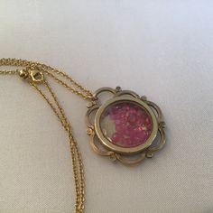 "Antique Art Nouveau Guilloche Locket filled with rubies. The gemstones move freely in the double-sided locket. The precious gems are gorgeous and beautiful quality. I meticulously search the world for the best quality and price. The gold-plated Guilloche round locket is from the early 1900's and a Gorgeous statement piece. It has a diameter of approx. 1 1/8\" and sparkles with rubies! It hangs from a 18\" gold-plate chain that extenders to 30\". It will come to you in a gift box. The Perfect gi Heirloom Gold Ruby Jewelry, Handmade Heirloom Necklace, Handmade Heirloom Round Necklace, Heirloom Handmade Round Necklace, Antique Gold Flower Pendant Jewelry As Gift, Heirloom Ruby Jewelry In Gold, Vintage Pendant Jewelry For Celebration, Antique Pendant Jewelry For Celebration, Vintage Pink Gold Jewelry For Gift