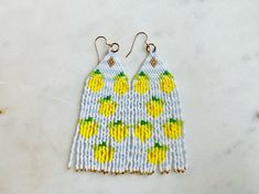 When life gives you lemons...you wear them! These earrings are absolutely gorgeous and will keep you 'cool' this summer! These earrings are made with delicate Miyuki Delica beads and each bead is hand woven. These are super light.  The ear wire is base metal and is nickel and lead free. Please let me know if I can answer any questions. I can customize any order too! Visit my Etsy shop for more: https://etsy.me/3my7URS Length - 3 inches Drop length - 3.5 inches Width - 1 inch Summer Yellow Dangling Beads Earrings, Yellow Summer Earrings With Dangling Beads, Yellow Dangling Beads Earrings For Summer, Summer Yellow Earrings With Dangling Beads, Yellow Beaded Drop Earrings For Summer, Yellow Beaded Earrings For Summer Beach, Summer Beaded Earrings With Fringe And Round Beads, Summer Beaded Earrings With Round Beads And Fringe, Summer Beaded Fringe Dangle Earrings