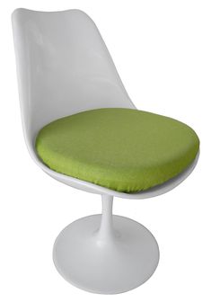 a white chair with a green cushion on it