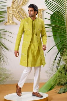 Fresh green full sleeve sherwani with gold filigree lotus applique embroidered motifs and embellished with cutpipe work. Paired with kurta and ivory pant pyjama.
Components: 3
Pattern: Embroidery, Embellished
Type Of Work: Cutpipe
Neckline: Mandarin collar
Sleeve Type: Full sleeves
Fabric: Sherwani: Cotton Linen, Kurta: Pure Cotton, Pant Pyjama: Vegan Silk
Color: Green
Other Details: 
Disclaimer: The fabrics used, are handwoven, hence may have impurities or slubs/variation in the weave that beau