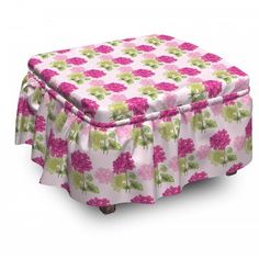 a pink and green flowered ottoman cover on top of a wooden footstool