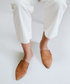 The mule is our best-seller for a reason. A slip-on pointed toe with an open back, the classic mule slide is handcrafted in Italy from supple suede with leather piping. A padded insole and elastic gussets offer ultimate comfort. Chic Almond Toe Leather Mules, Chic Brown Pointed Toe Mules, Fall Workwear Pointed Toe Suede Flats, Chic Mules With Almond Toe And Leather Footbed, Chic Closed Toe Mules For Workwear, Flat Heel Mules With Leather Sole For Work, Flat Heel Leather Sole Mules For Work, Workwear Flat Heel Mules With Leather Sole, Chic Mules With Leather Footbed And Almond Toe